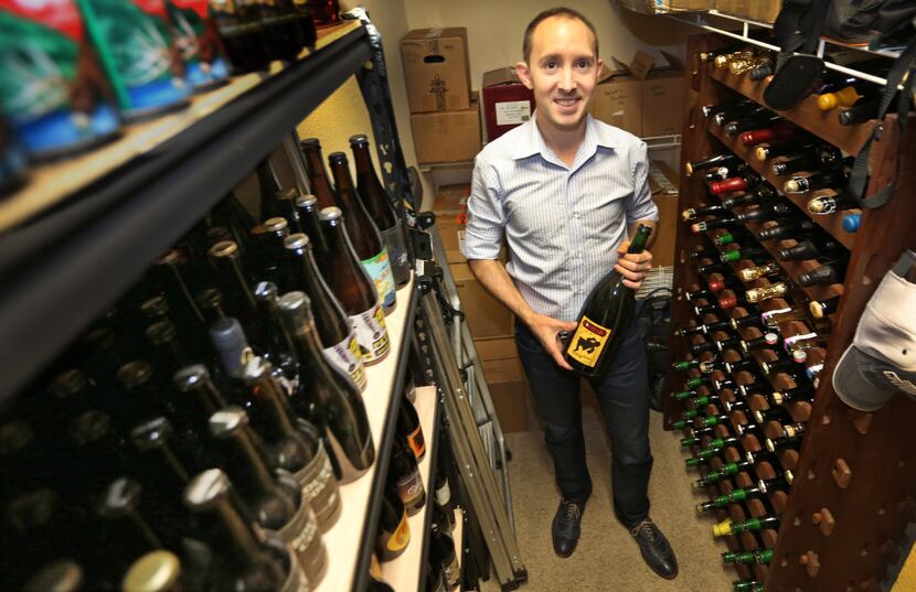Thomas Berg is pictured at his home with his collection of unique and exotic beers in Plano.