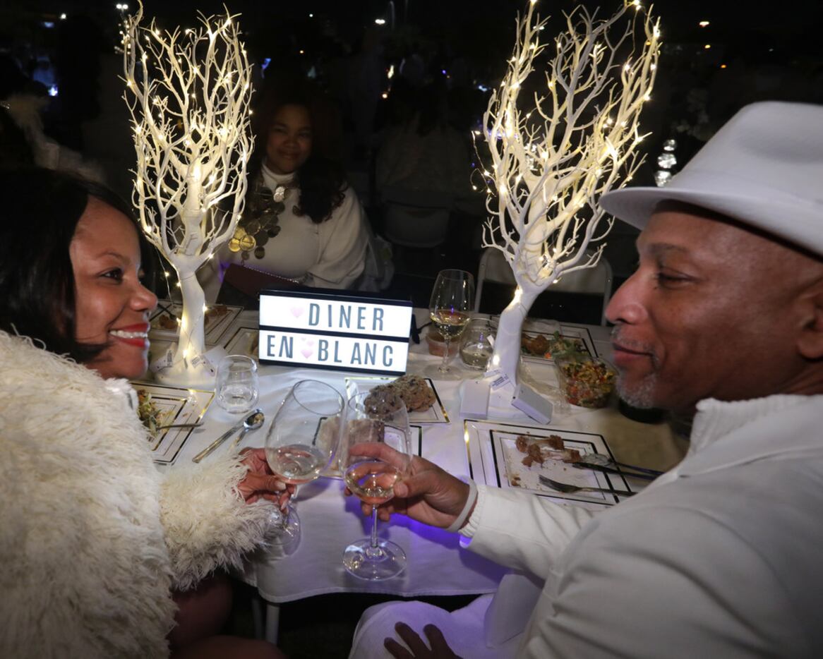 Serena Wright (left) and Levenis Wright toast during a secret Diner en Blanc event at...