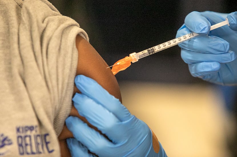 Medical personnel vaccinate students at a school in New Orleans on Jan. 25, 2022. A Centers...