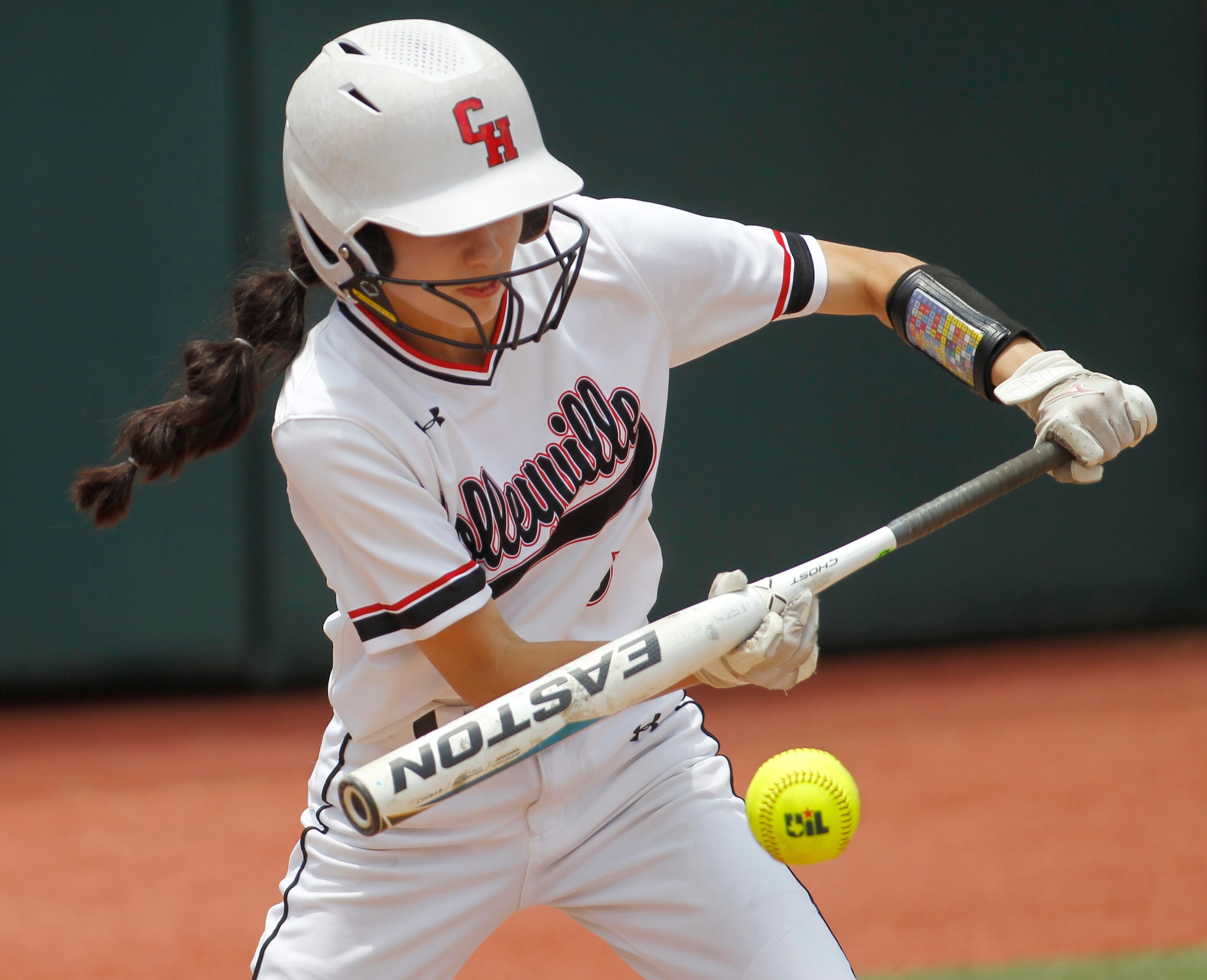 Colleyville Heritage outfielder Leah Perales (5) lays down a bunt during top of the fourth...