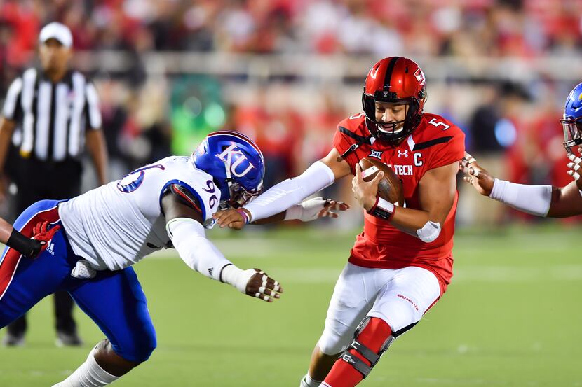 LUBBOCK, TX - SEPTEMBER 29: Patrick Mahomes II #5 of the Texas Tech Red Raiders stiff arms...
