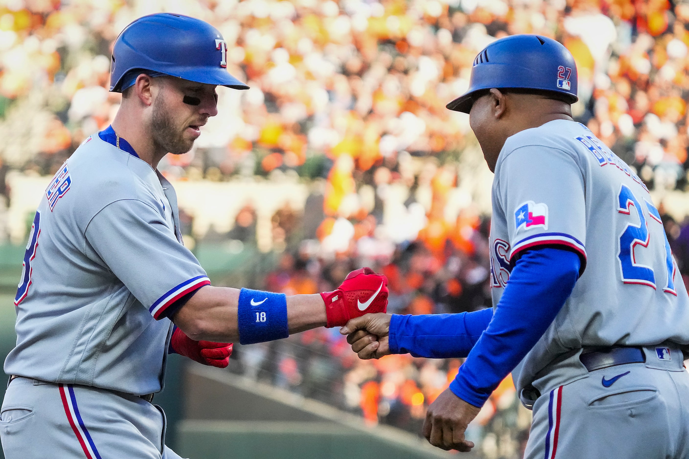 Texas Rangers designated hitter Mitch Garver celebrates with third base coach Tony Beasley...