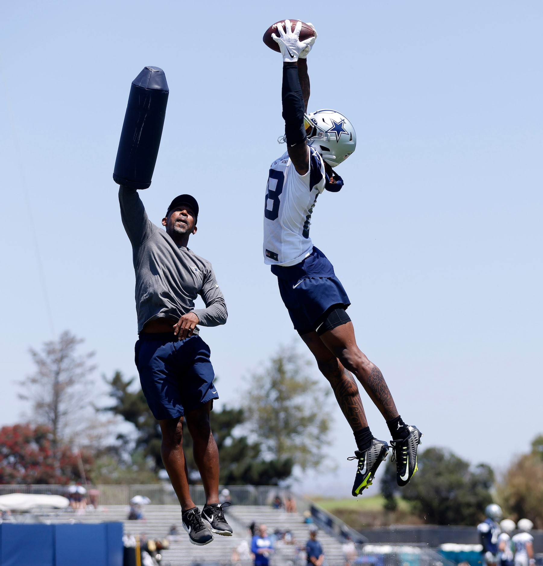 Dallas Cowboys wide receiver CeeDee Lamb (88)  skies high over wide receivers coach Robert...