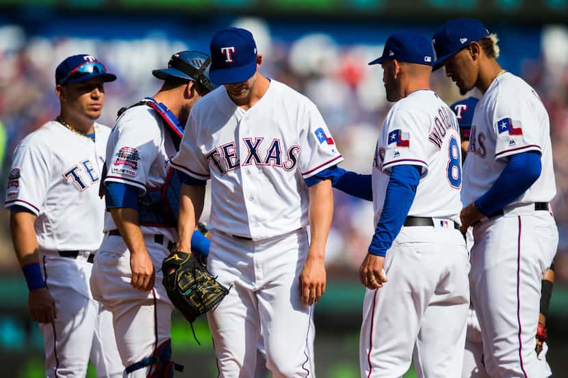 Texas Rangers starting pitcher Mike Minor (23) leaves the mound during the fifth inning of...
