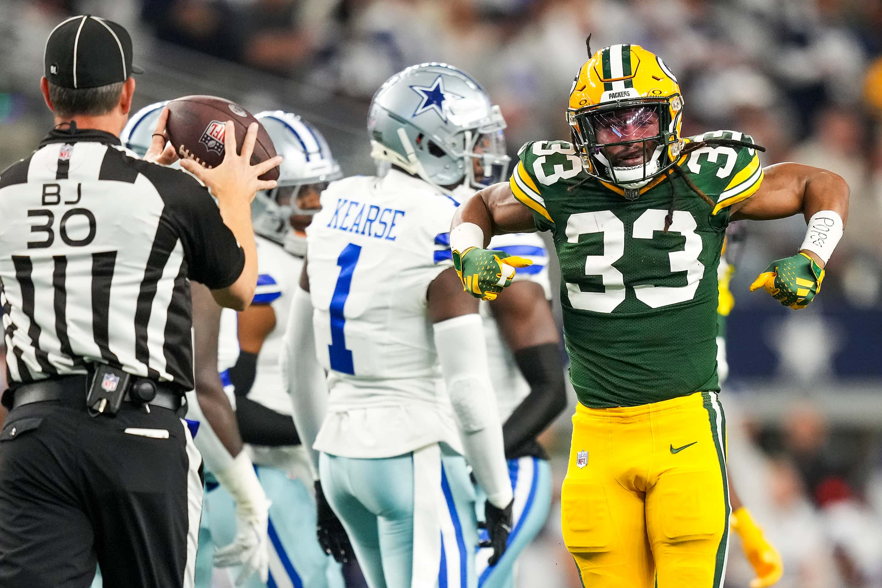 Green Bay Packers running back Aaron Jones (33) celebrates after picking up a first down...