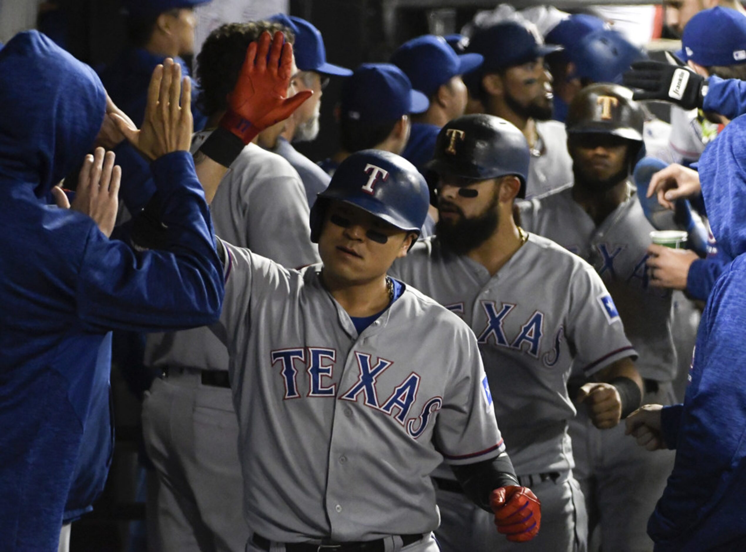 CHICAGO, IL - MAY 18: Shin-Soo Choo #17 of the Texas Rangers is greeted by his teammates...