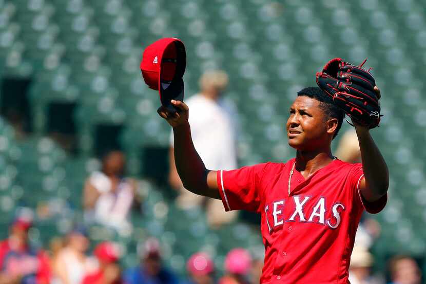 Texas Rangers relief pitcher Jose Leclerc (62) gestures to the sky after finishing out the...