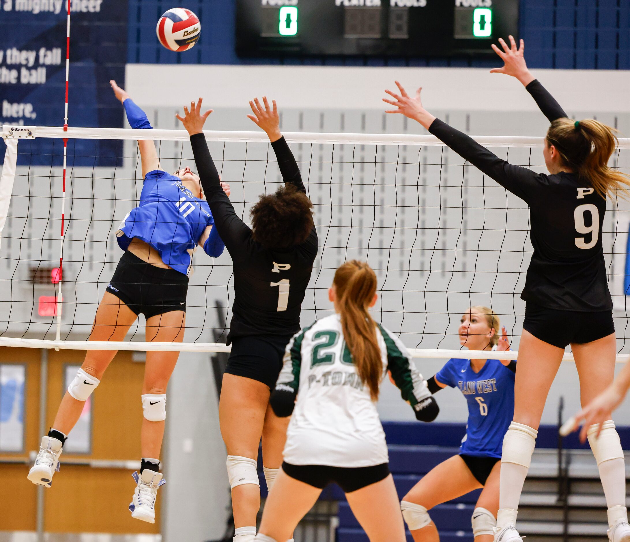 Plano West’s Kate Mansfield (left) spikes the ball against Prosper high’s Jayla Jackson (1)...