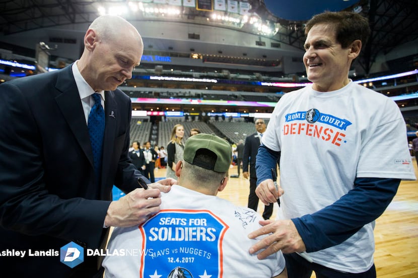 Dallas Mavericks head coach Rick Carlisle and Owner Mark Cuban sign the shirt of U.S. Army...