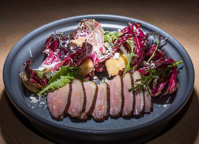 Smoked duck salad has rosy, intensely smoked slices of breast meat fanned alongside grilled...