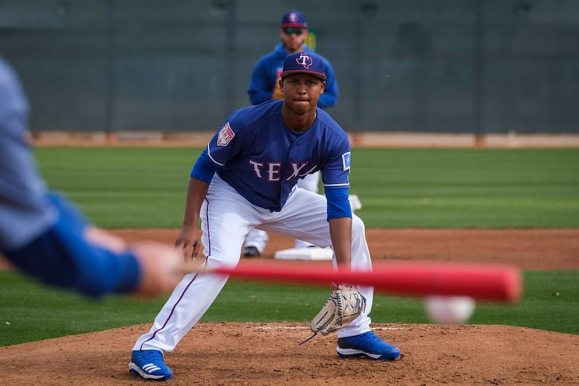 Texas Rangers pitcher Jose Leclerc participates in fielding practice during the first...