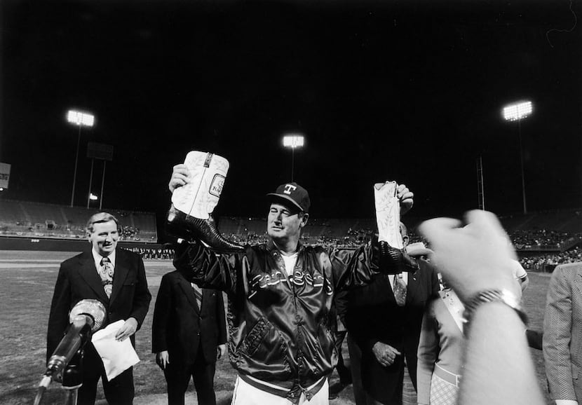Former Texas Rangers manager Ted Williams receives a pair of Cowboy boots during a ceremony...