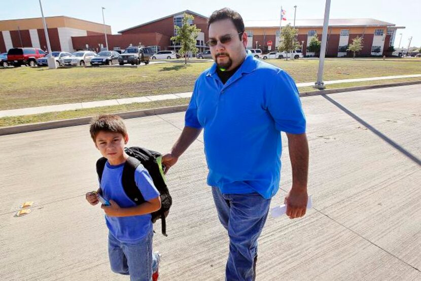 
Roland Kennedy and son Lukas, 7, left Lake Pointe Elementary in Fort Worth on Friday....