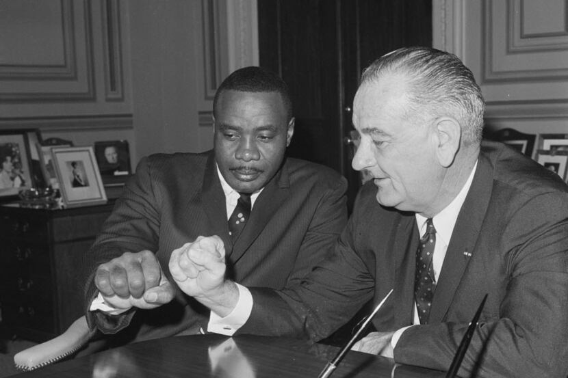 Heavyweight boxing champion Sonny Liston and Vice President Lyndon Johnson compared fists in...
