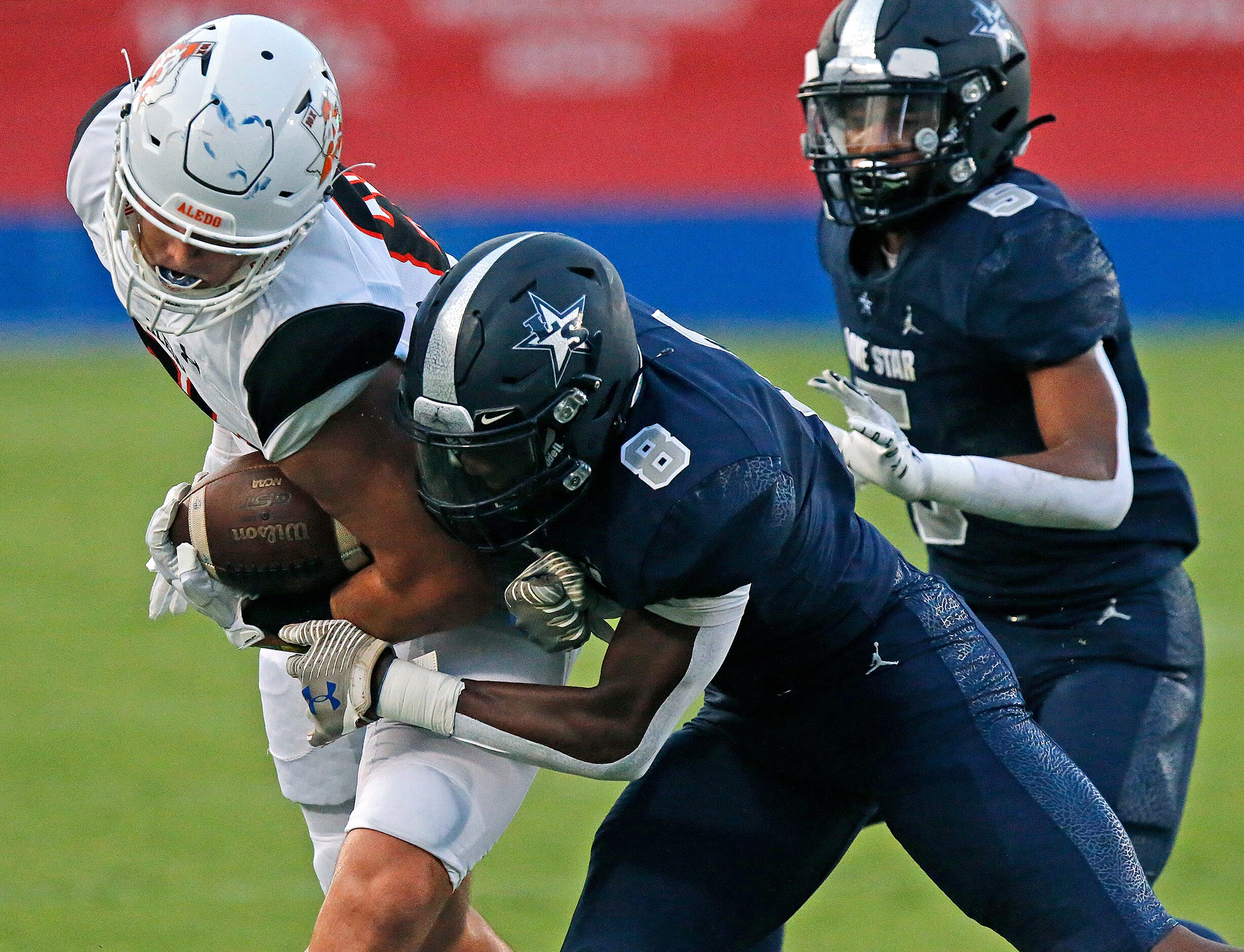 Aledo High School tight end Jason Llewellyn (89) is met by Lone Star High School defensive...