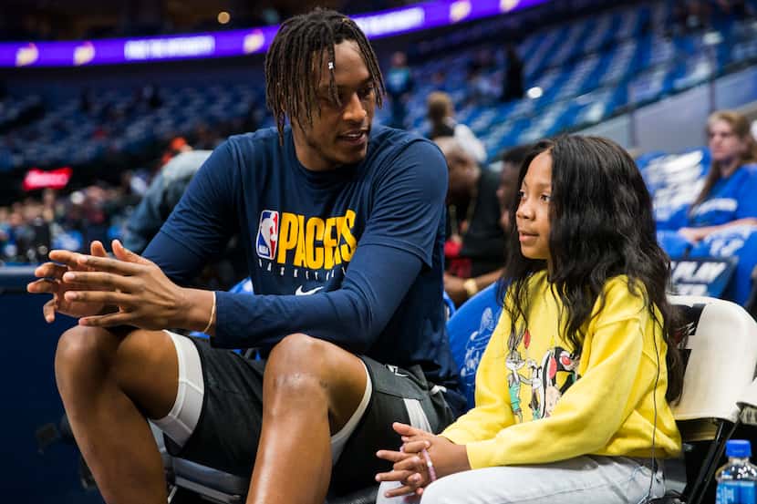 A'Myah Moon (right), 11, talks with Indiana Pacers center Myles Turner (33) before an NBA...