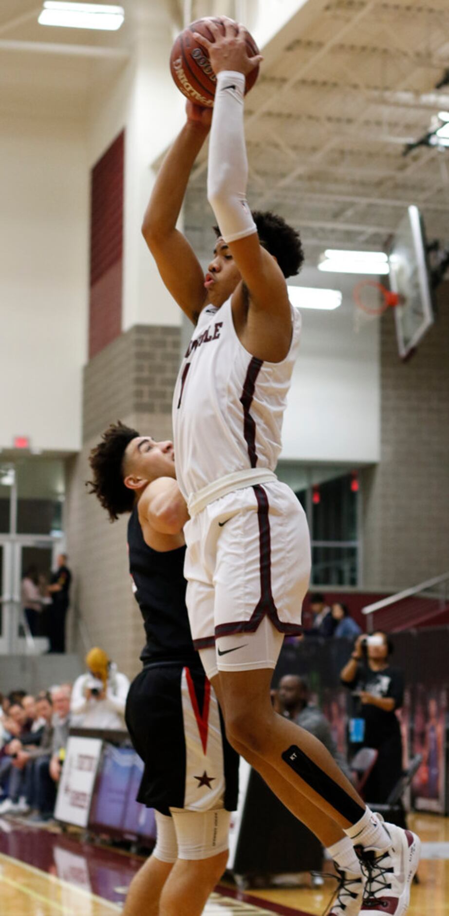 Lewisville's Keyonte George (1) skies to pull in a tall pass over the defense of Coppell's...