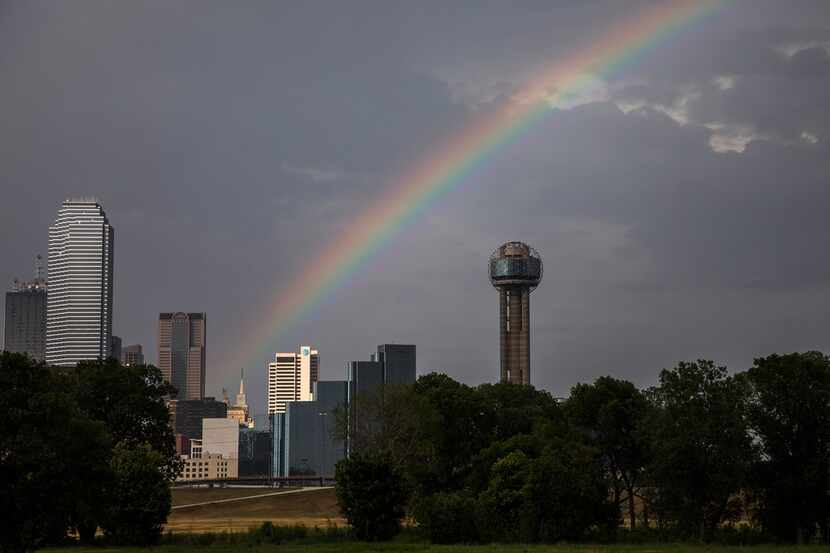 Afternoon showers give way to a rainbow over downtown on Monday, July 9, 2018, in Dallas....