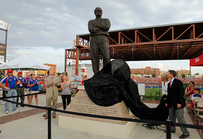 Members of the Hunt family unveil a nine-foot-tall, bronze statue of Lamar Hunt before FC...