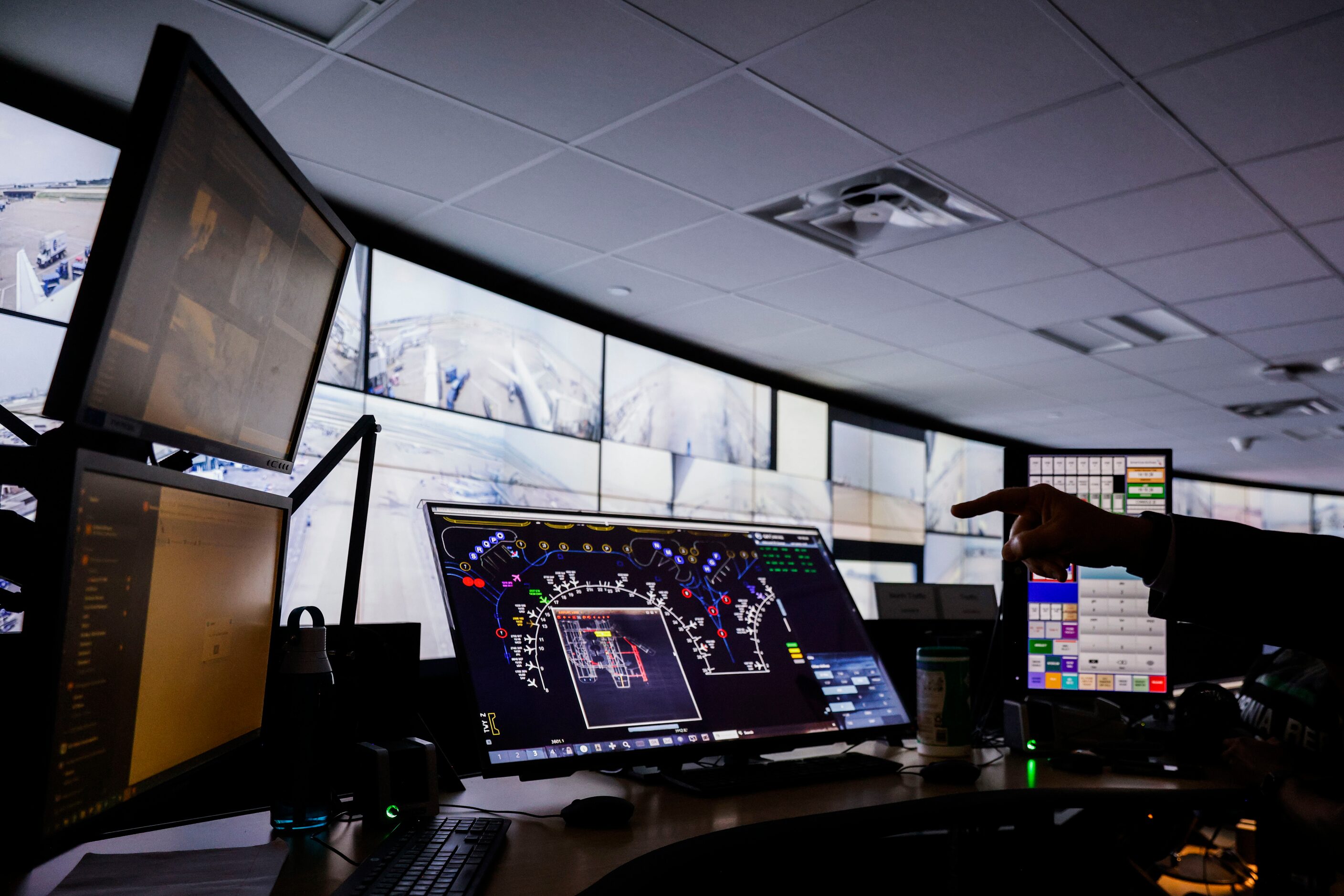 Employees work at American Airlines command center, where the airline directs its ground...