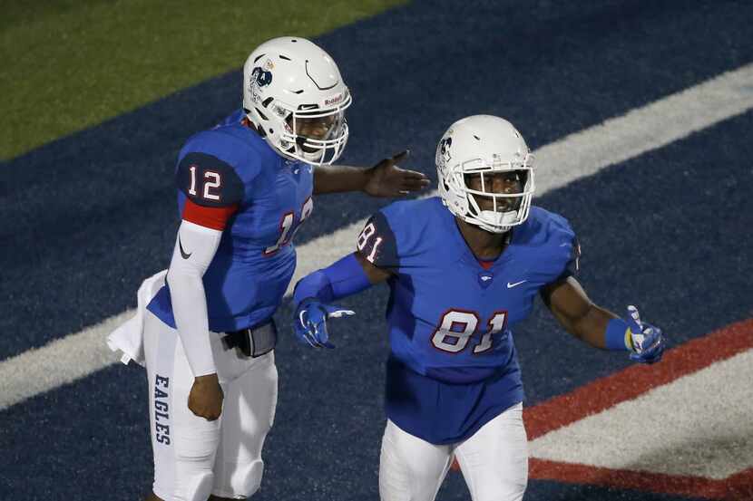 Allen's Tevyn Stevenson (81) is congratulated by quarterback Grant Tisdale (12) for his...