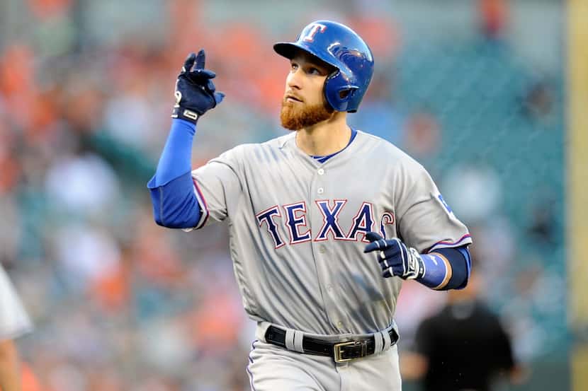 BALTIMORE, MD - AUGUST 04: Jonathan Lucroy #25 of the Texas Rangers celebrates after hitting...
