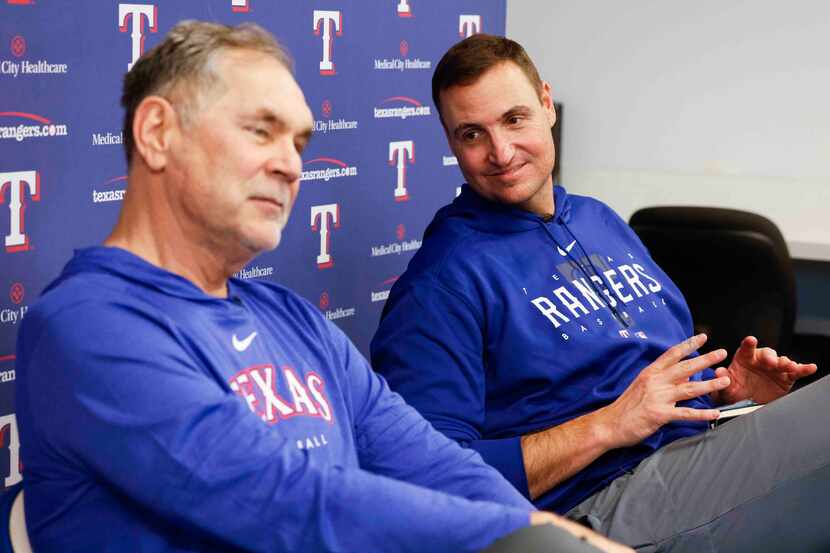 Texas Rangers manager Bruce Bochy, left, talks to the members of the media as executive vice...