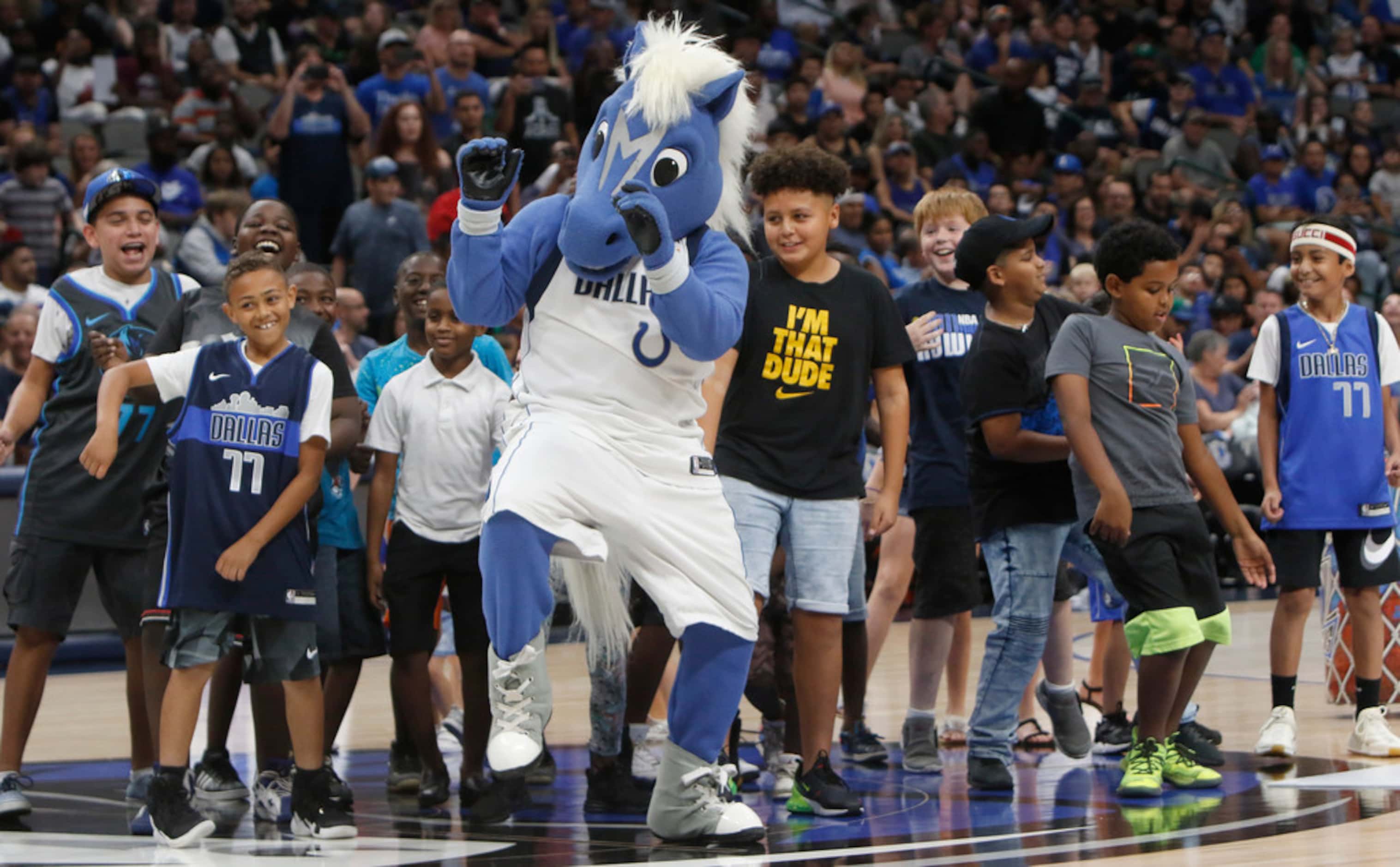 Led by Dallas Mavericks mascot "Champ", young Mavs fans practice their dance moves at mid...