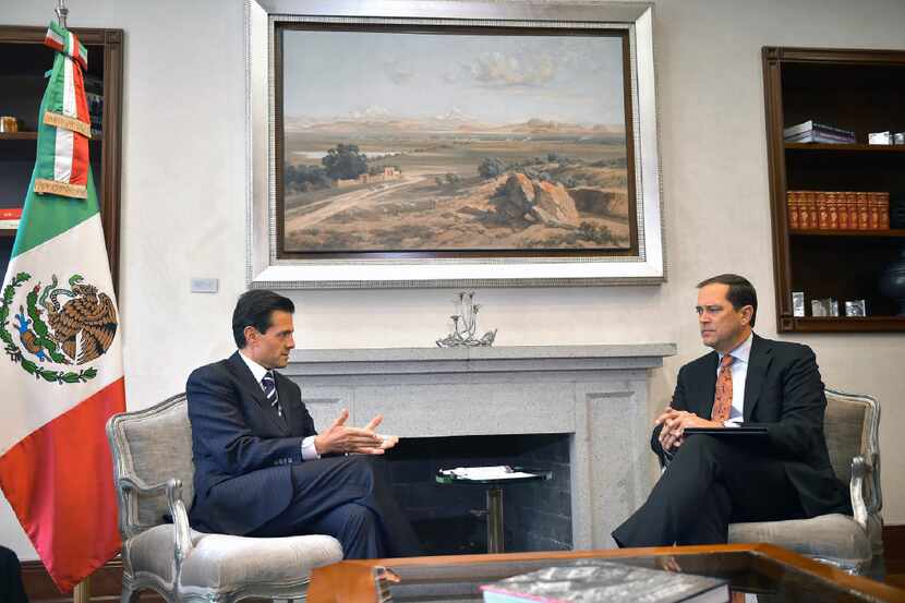 Mexican President Enrique Pena Nieto (left) talks with Cisco CEO Chuck Robbins during a...