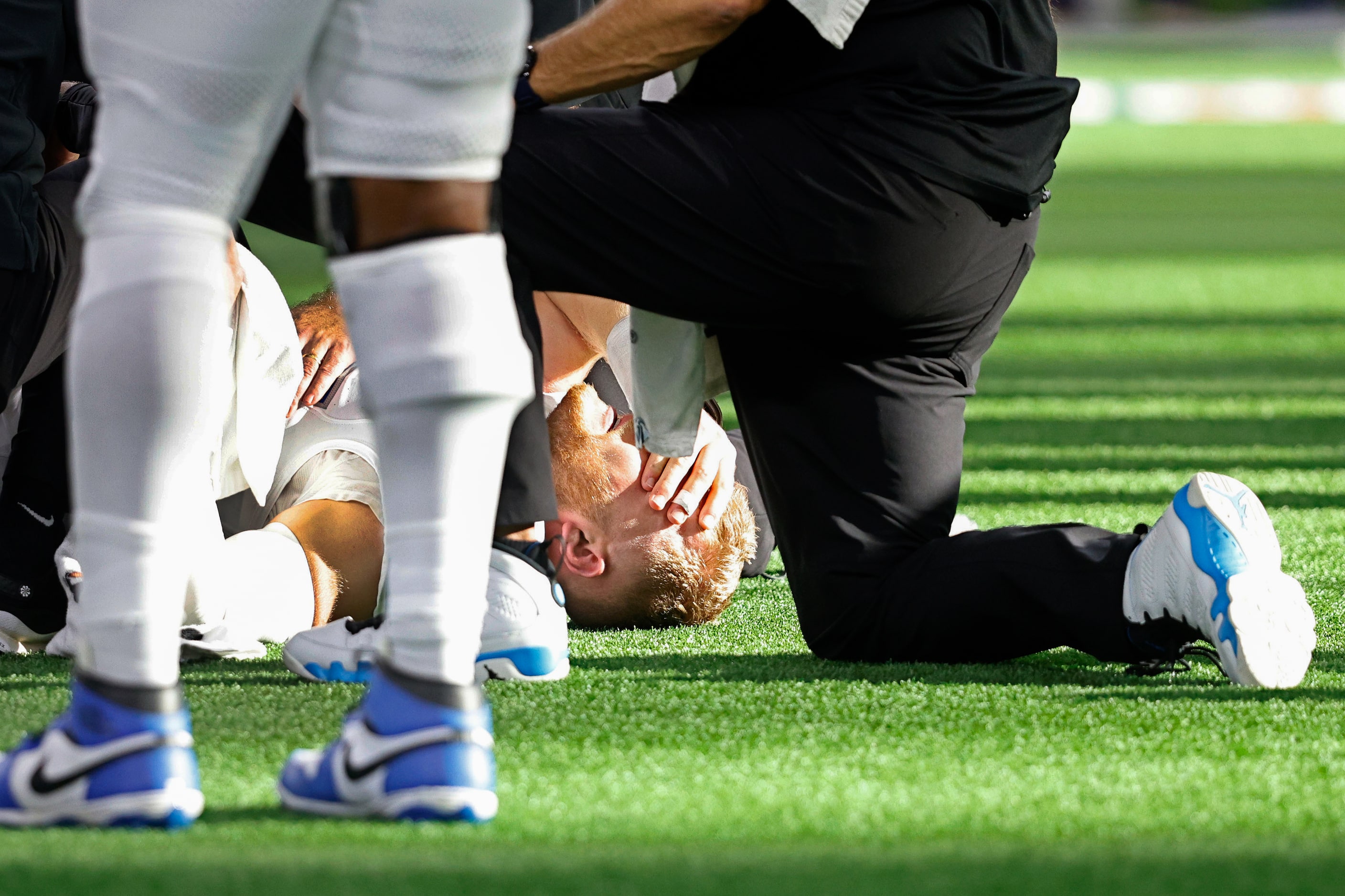 Detroit Lions defensive end Aidan Hutchinson (97) is checked out after his injury in the...