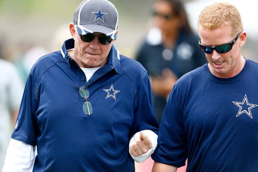 Dallas Cowboys owner and general manager Jerry Jones confers with head coach Jason Garrett...