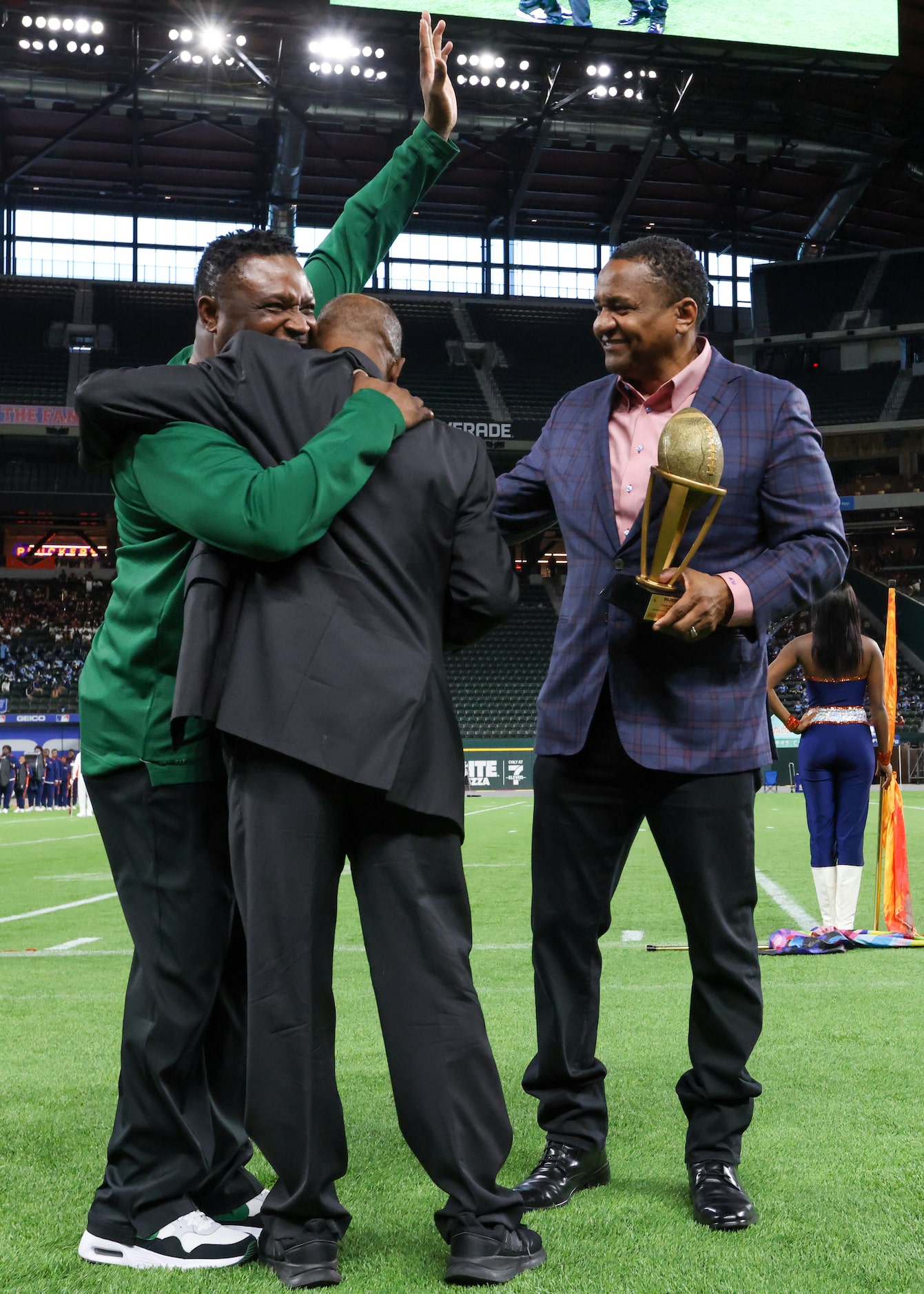 DeSoto High School head coach Claude Mathis (left) greets Johnny King (center) and Mitchell...