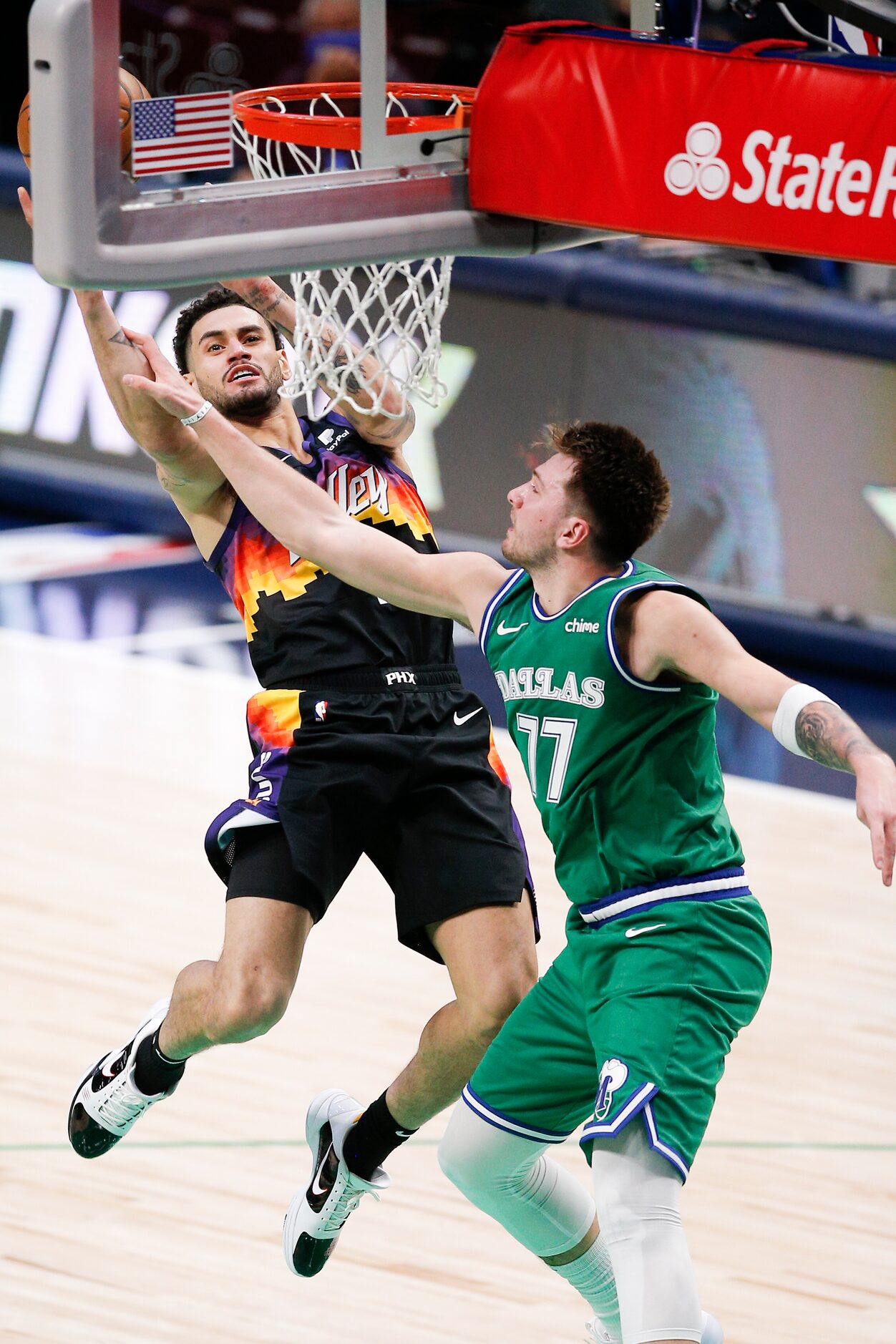 Dallas Mavericks guard Luka Doncic (77) fouls Phoenix Suns forward Abdel Nader during the...