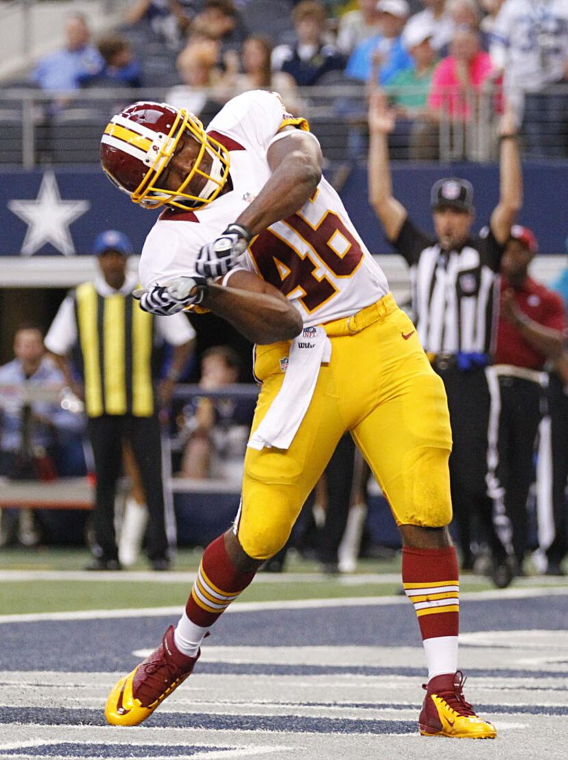 Washington Redskins running back Alfred Morris (46) swings a homerun in the end zone after...