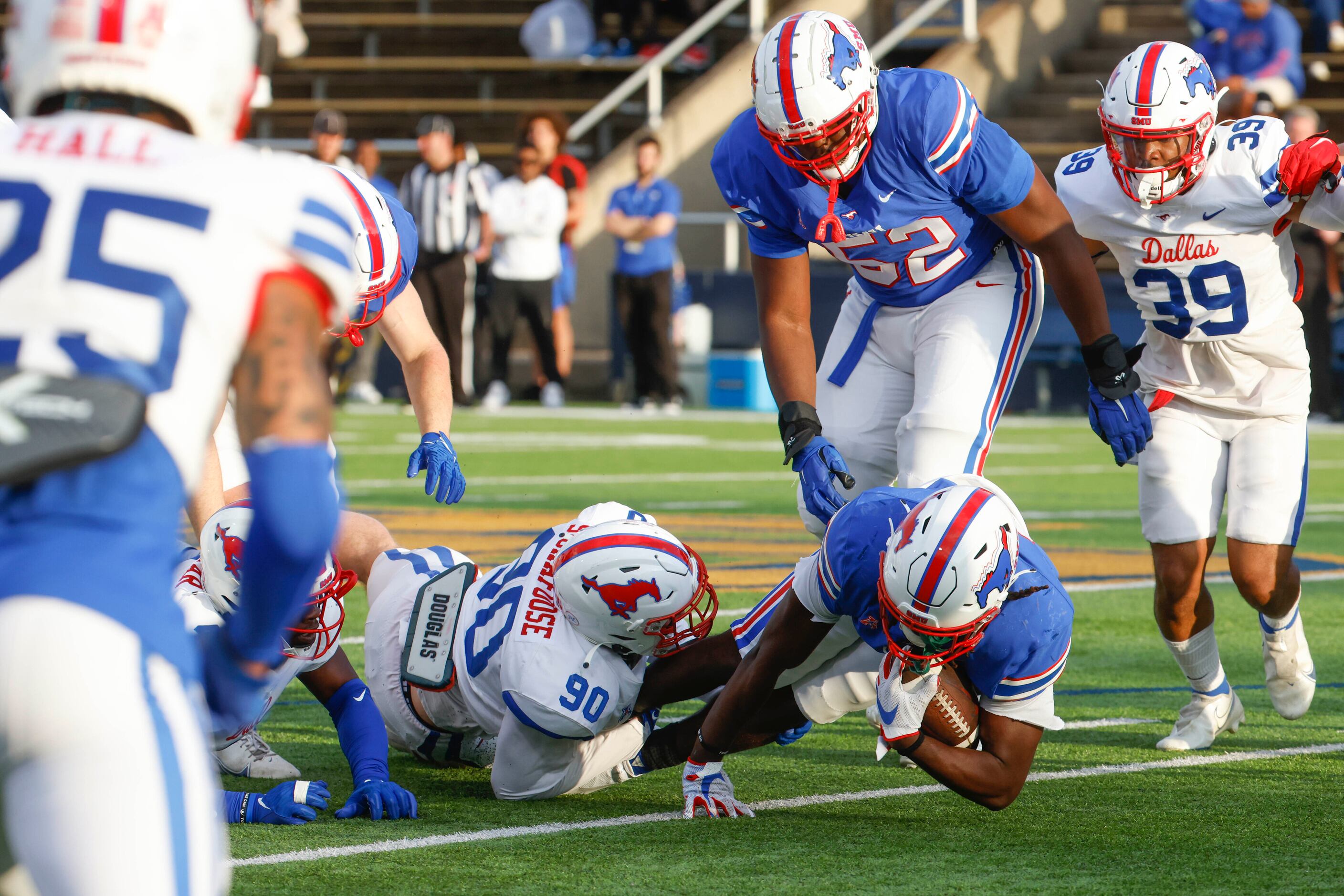 SMU’s Alex Sickafoose (left) tackles Southern Methodist wide receiver Rashee Rice during an...