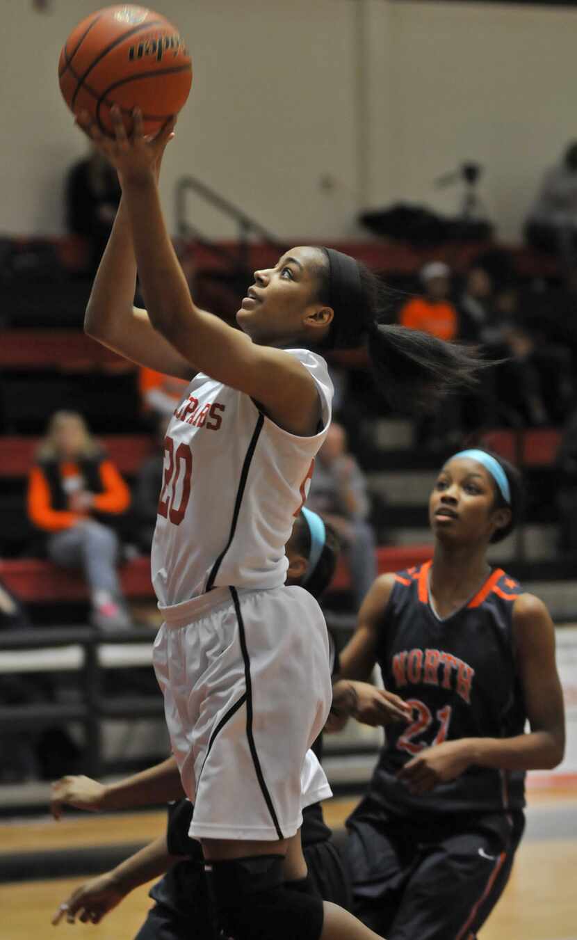 Lovejoy senior Shani Rainey (20) leaps for a layup in front of McKinney North senior...