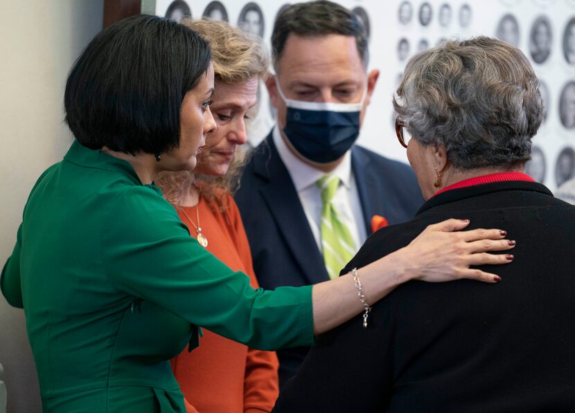 Democratic colleagues surround state Rep. Donna Howard (in orange) after she challenged...