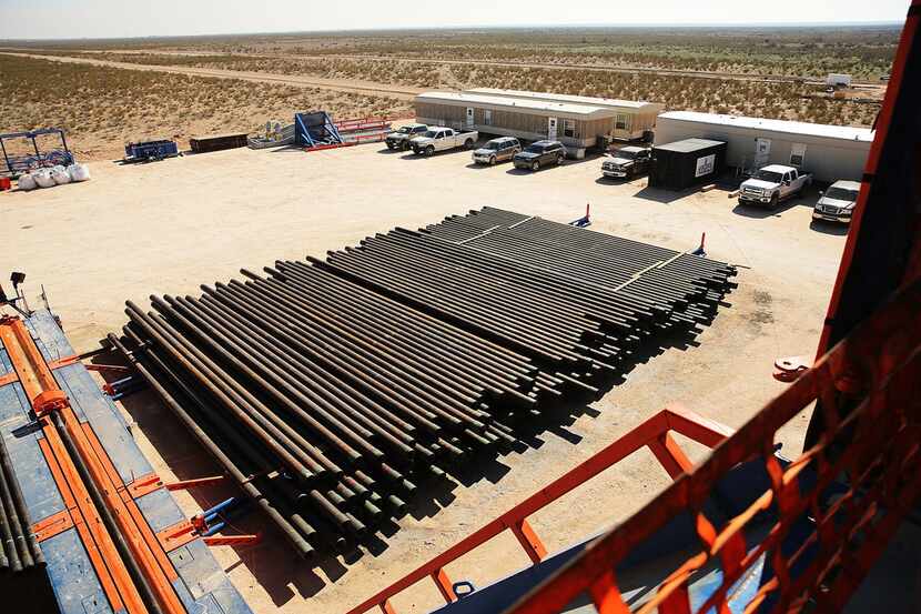 Drilling pipes are viewed for the Patterson 298 natural gas fueled drilling rig on land in...
