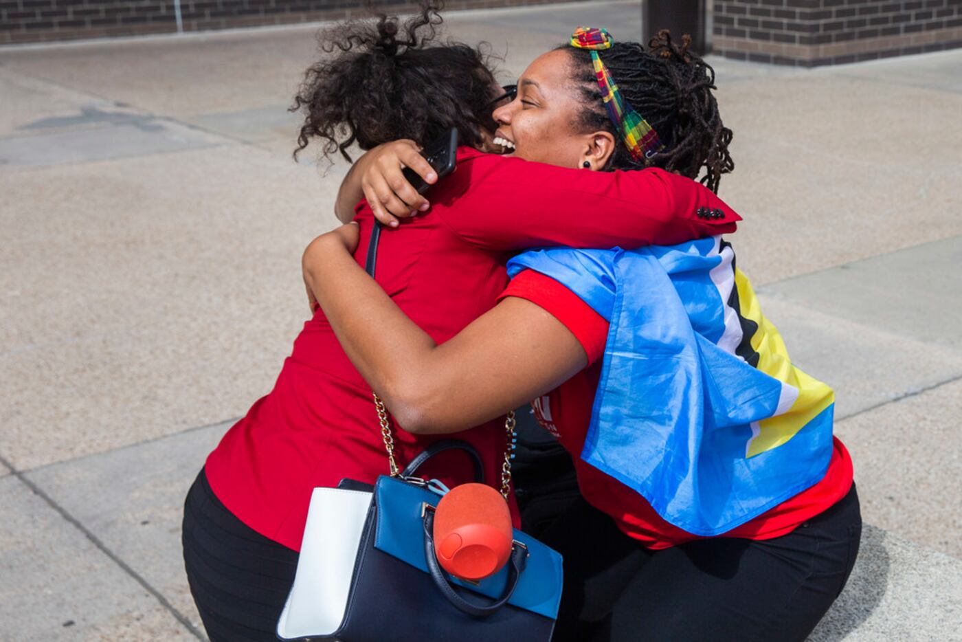 Outside the courthouse, St. Lucian activist Safiya Paul (right) embraces Jennifer Cortez,...
