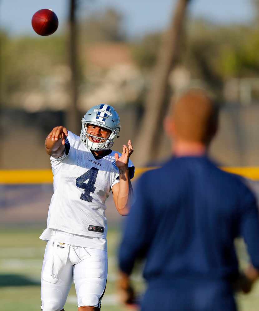 Dallas Cowboys quarterback Dak Prescott (4) plays catch with head coach Jason Garrett...
