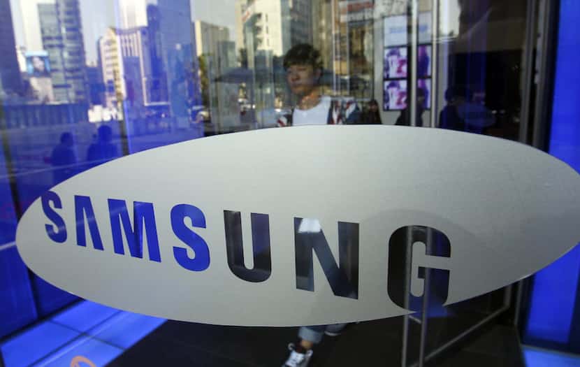 A visitor passes by the logo of Samsung Electronics Co. at a showroom of its headquarters in...
