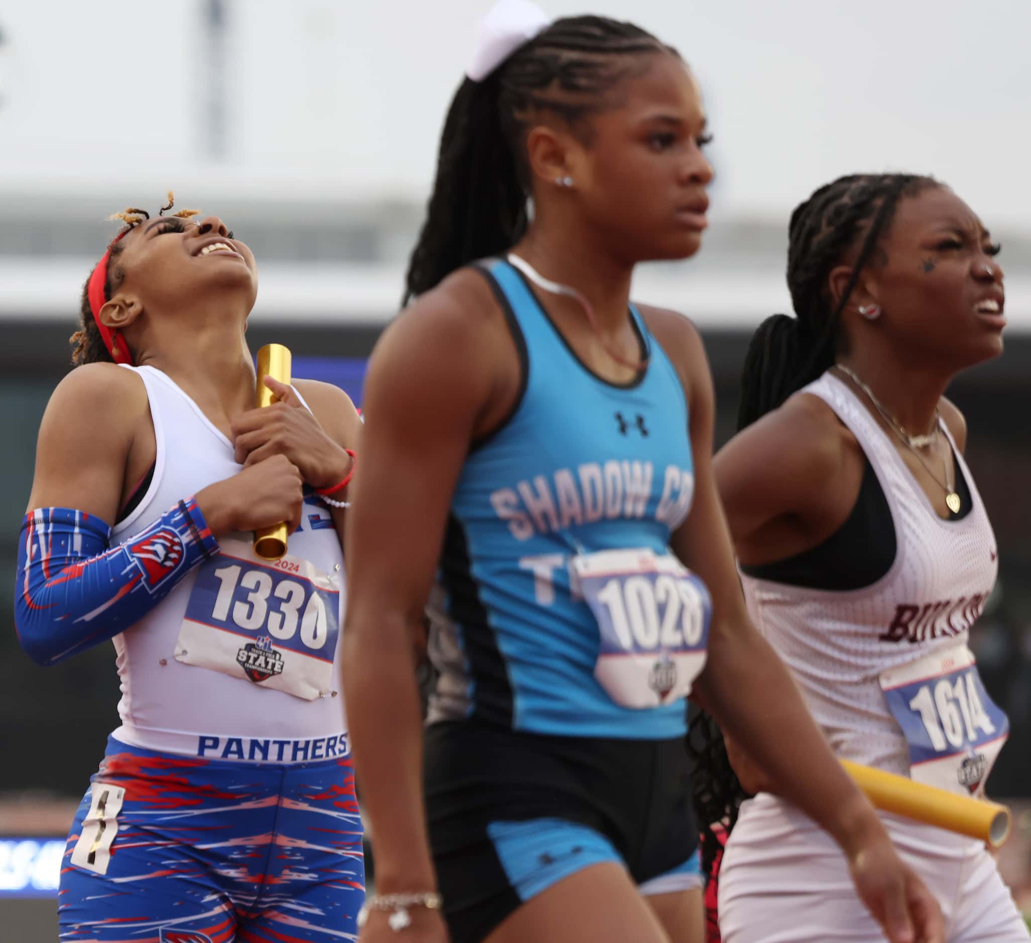 Duncanville sprinter Sanyah Keeton, left, revels in the moment after being the first to...