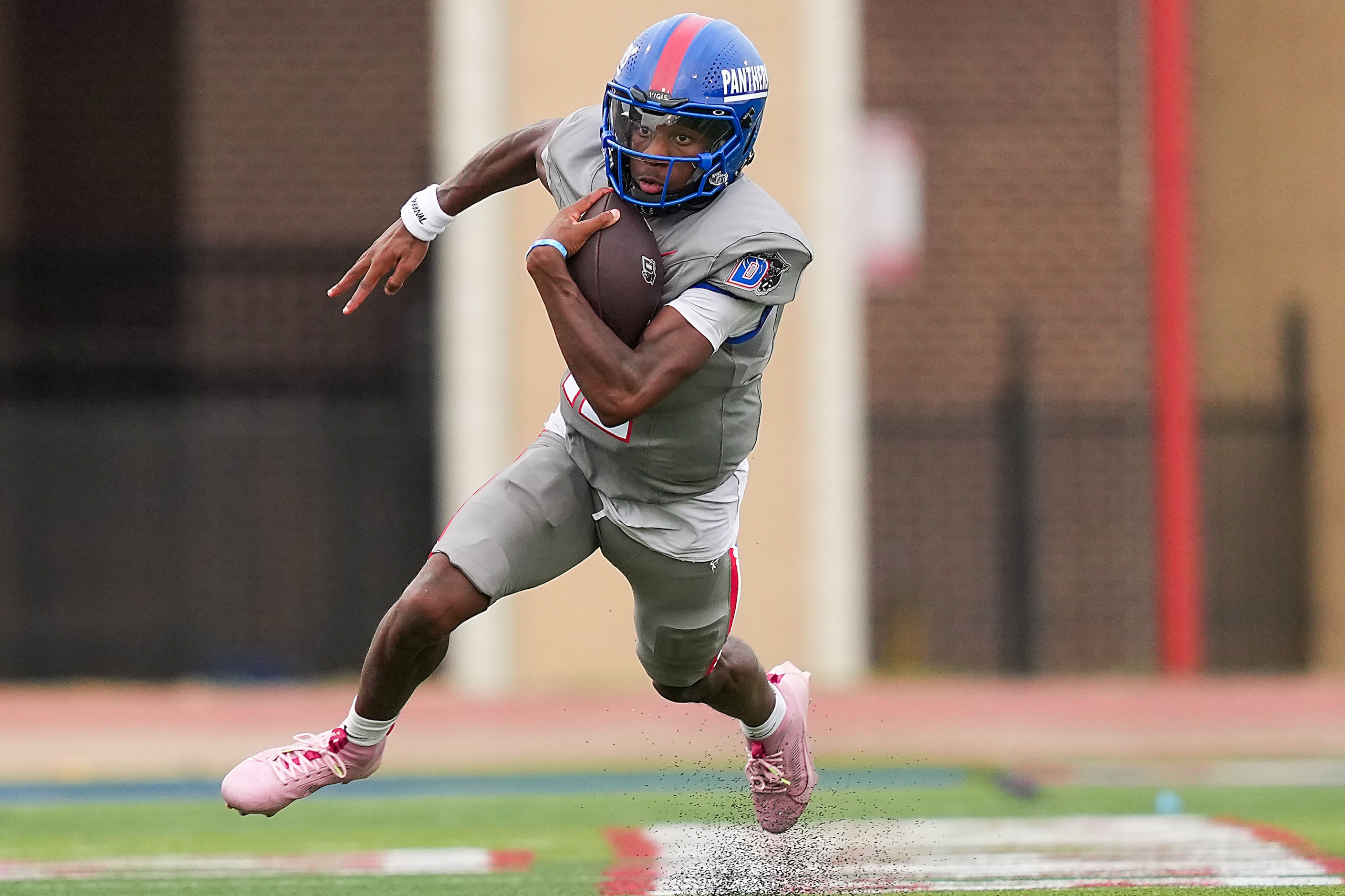 Duncanville quarterback Keelon Russell runs the ball during a high school football game...