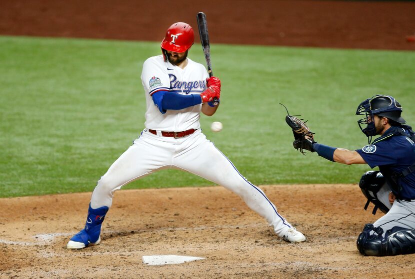 Texas Rangers center fielder Joey Gallo (13) leans back from an inside pitch by Seattle...