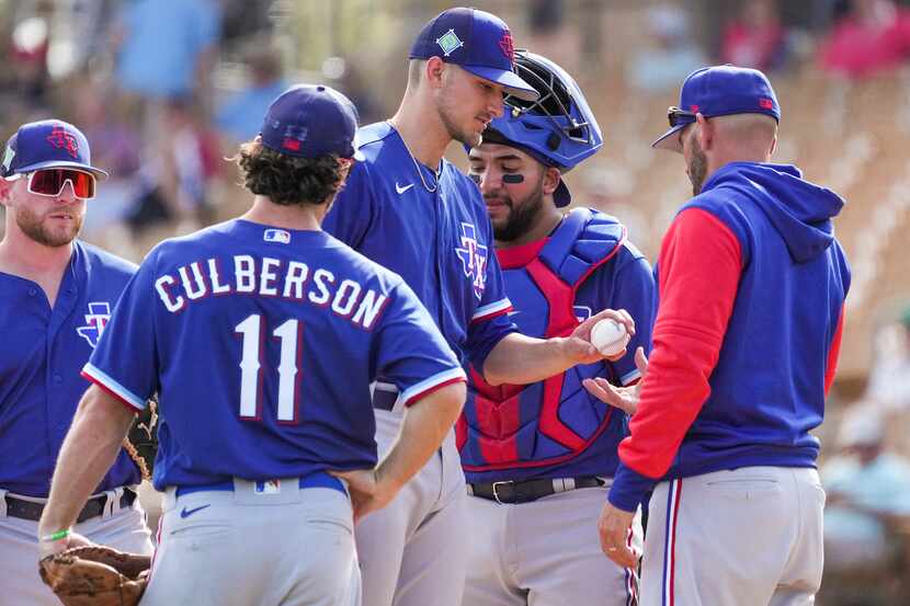 Texas Rangers pitcher Brett Martin hands the ball to manager Chris Woodward as he is pulled...
