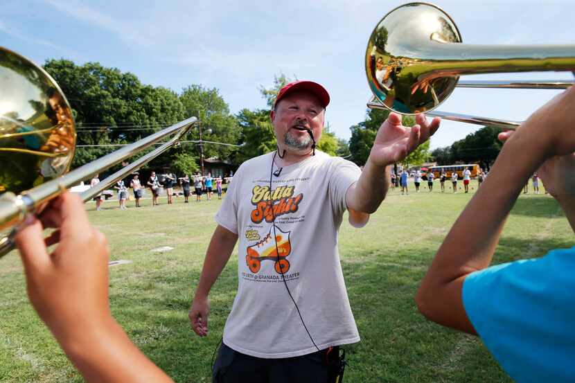 Woodrow Wilson band director Chris Evetts coaches band students during practice at Woodrow...
