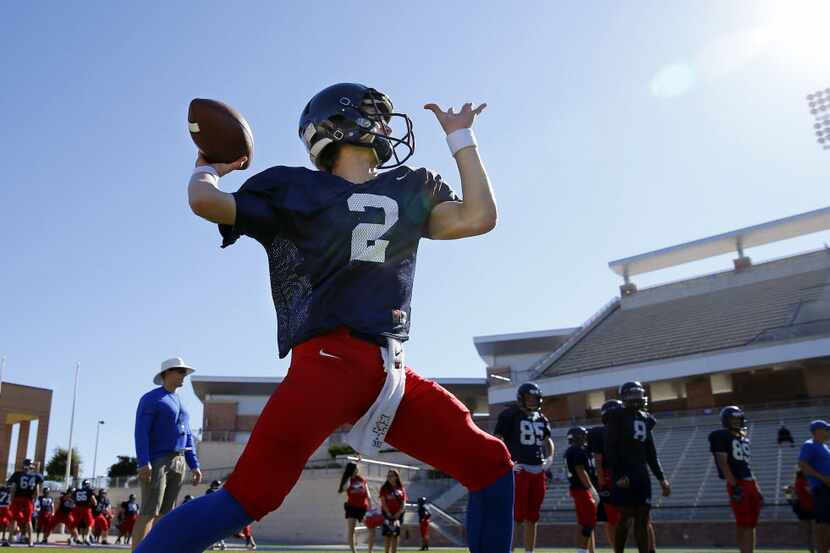 Allen High quarterback Mitchell Jonke throws a pass during spring football practice at Eagle...