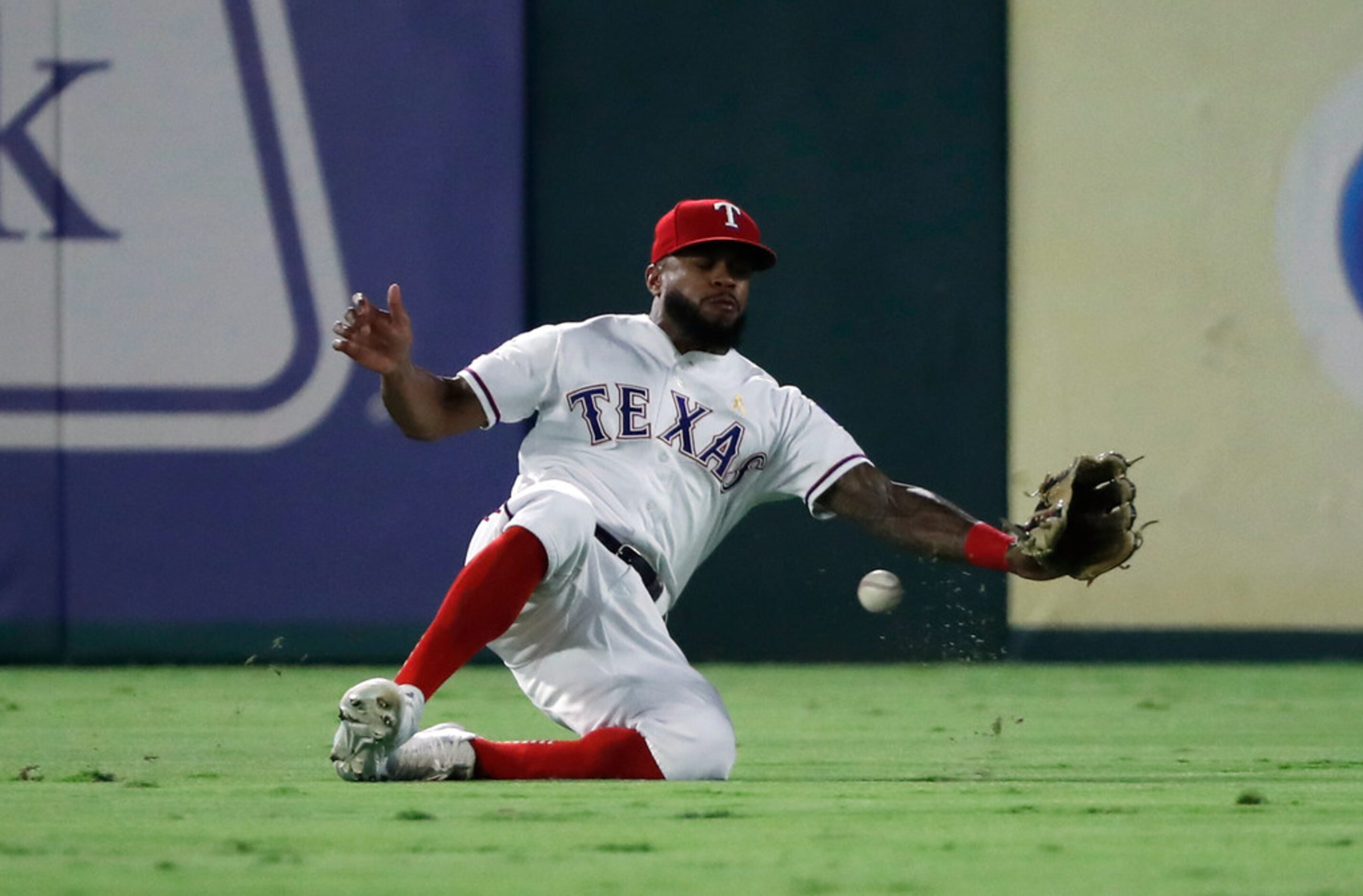 Texas Rangers center fielder Delino DeShields is unable to catch a ball hit by Oakland...