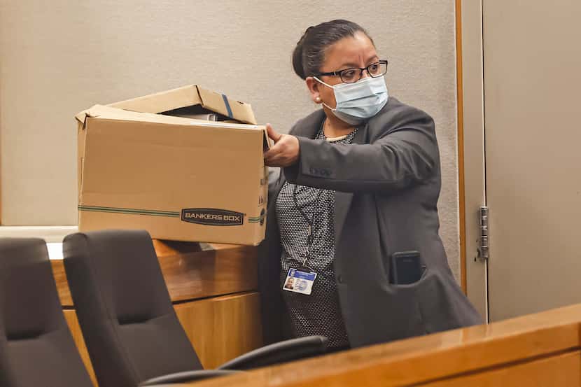 Dallas Police Detective Christine Ramirez packs up a box of case files from Dallas Police...