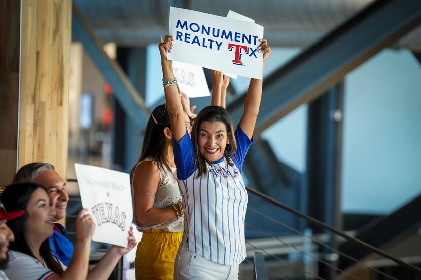 Realtor Coral Rojas-Acosta cheers with her co-workers during a Monument Realty outing to a...